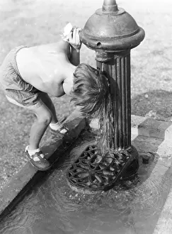 Hydrant: Young child with head under hydrant