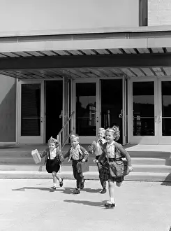 Aerobic: Four young children with bags and lunch boxes
