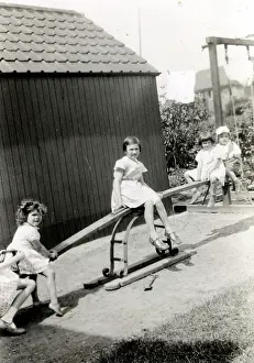 Lucinda Moore: Four young children playing on a see-saw