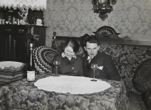 Doring: Young couple on a bed. A table with