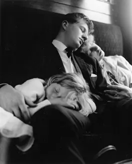 Young couple and child sleeping in a train compartment
