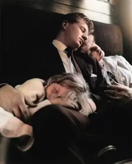 Young couple and child sleeping in a train compartment