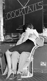 Clinch: Young couple having a kiss and cuddle
