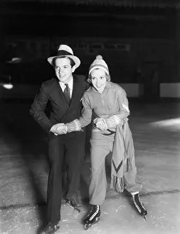 Cooperate: Young couple ice skating together