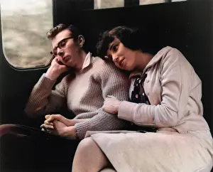 Young couple relaxing in a train compartment