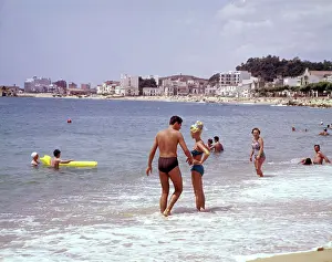 Blanes: Young couple standing in the sea, Spain