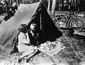 Snack: Young couple in front of a tent