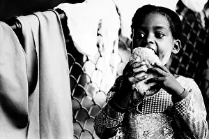 Icing: Young Cuban girl eats a pastry