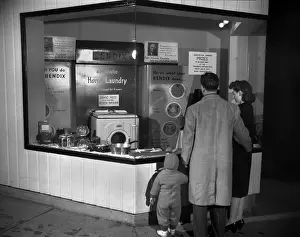 Lcgr1409: Young family look at the Bendix Automatic Home Laundry