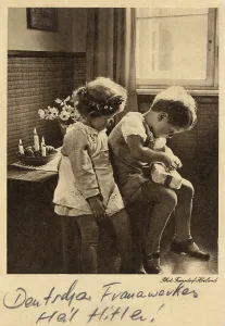 Unwrapping: Young german Boy opens a present - Heil Hitler text at base