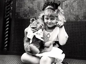 Dimple: Young girl making a point to her teddy bear