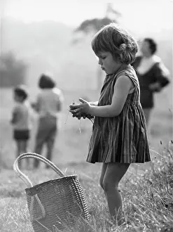 The John Krish Collection: Young girl in a park with grass in her hands