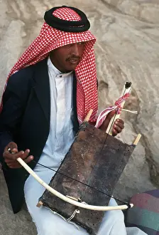 Jordanian: A young Jordanian man plays a rababah