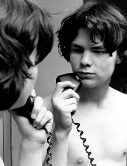 Shaver: Young lad using an electric razor