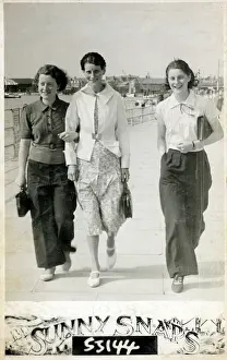 Chums: Three young ladies strolling along the seafront