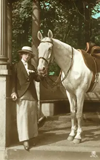 Equestrianism: A young lady with her fine grey horse