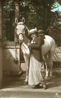 Equestrianism: A young lady with her fine grey horse