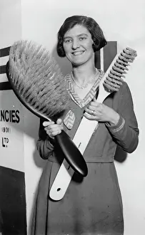 Hairbrush: A young lady shows a giant toothbrush