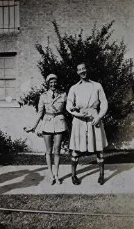 Garters: Young laughing couple she wears tie;