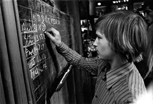 Darts: Young man chalking up darts scores in a pub