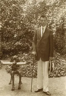 Crewcut: Young man with a dog in a garden