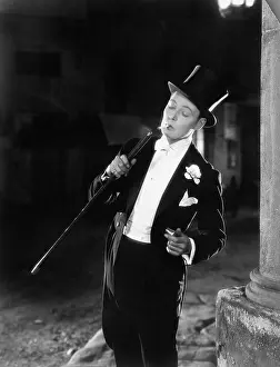 Formalwear: Young man in formal clothing lighting his cigarette