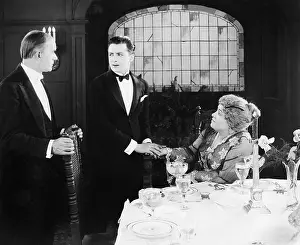 Formalwear: Young man greeting a couple at the dinner table