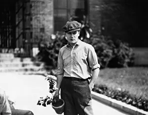 Abode: Young man holding a potted plant