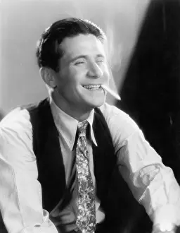 Waist Up: Young man laughing and smoking a cigarette