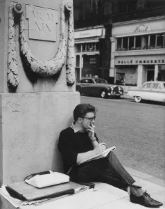 Concerts: Young man leaning against a monument, Manchester
