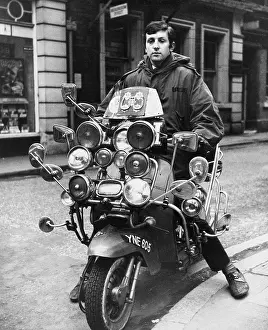 Headlamp: Young man on a motor scooter