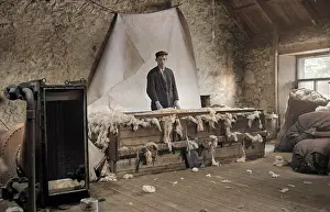 Floorboards: Young man processing wool, Scotland