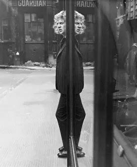 Young man reflected in glass window