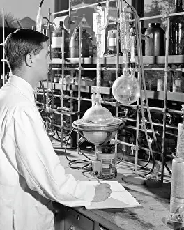 Beakers: Young Man Researcher Conducting Experiment in