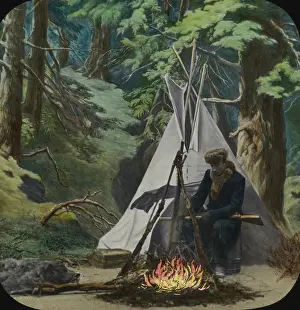 Wigwam: Young man sits by fire outside his teepee in the woods