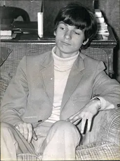 Specify: Young man sitting in an armchair