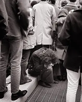 Disadvantaged: Young Man Sitting on Curb Head in his Lap in Midst