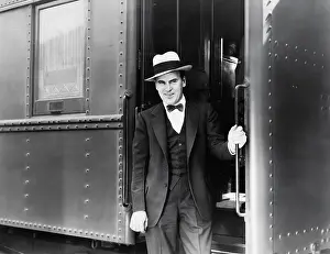 Fedora: Young man standing at the entrance of a train