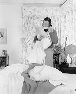 Pillows: Young man talking on the telephone and biting into