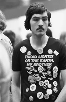 Earnest: Young man in teeshirt with slogan and badges
