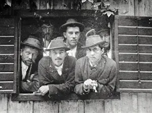 Mautner: Six young men - some with pipes - look Out of a