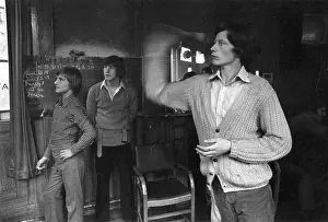 Chalked: Three young men playing darts in a pub