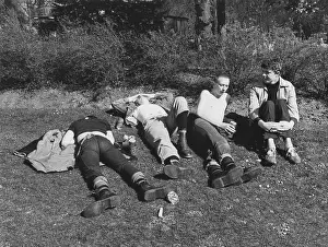 Sense: Four young men relaxing on the grass