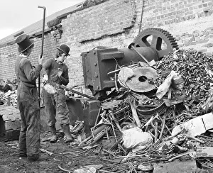 Cogwheel: Two young men sorting through a pile of scrap metal