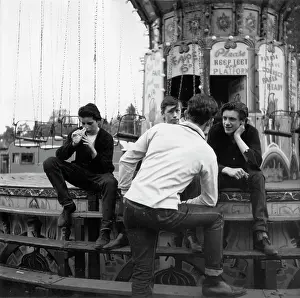 Drainpipe: Four young men on steps of fairground ride