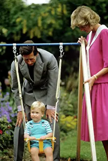 Dianna: A young Prince William on a swing next to his parents