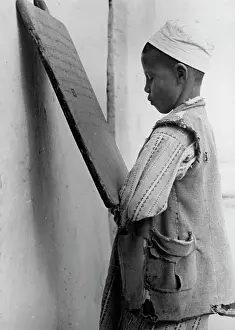 Schoolchild: Young scholar studying arabic letters