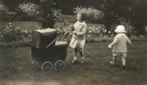 Oddington: Two young siblings playing with a beautiful toy pram