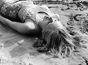 Worshipper: A young sun- worshipper on the beach