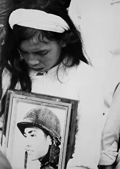 Mourns: An young Vietnamese widow mourns. Hugging ?